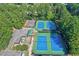 Aerial view of community tennis courts, playground, and parking area surrounded by trees at 4184 Westchester Ne Trce, Roswell, GA 30075