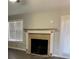 Inviting living room featuring an electric fireplace, light colored walls and large windows at 501 Owens Springs Ln, Mcdonough, GA 30252