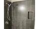 Modern shower stall with dark tile and a built in shelf at 501 Owens Springs Ln, Mcdonough, GA 30252