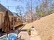 A spacious backyard features a wooden deck, patio, and mature trees at 112 Estates At The Lake Dr, Canton, GA 30114