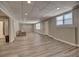 Spacious basement area with a neutral color palette and wood-look flooring, ready for customization and comfort at 112 Estates At The Lake Dr, Canton, GA 30114