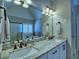 Bathroom vanity with double sinks, granite countertop, and decorative lighting at 112 Estates At The Lake Dr, Canton, GA 30114