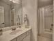 Bright bathroom featuring a vanity with sink, toilet, and shower with white curtains at 112 Estates At The Lake Dr, Canton, GA 30114