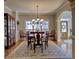 Dining room with an ornate chandelier, decorative rug, and plenty of seating at 112 Estates At The Lake Dr, Canton, GA 30114