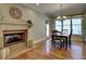 Cozy dining room featuring a fireplace, chandelier lighting, and hardwood floors at 112 Estates At The Lake Dr, Canton, GA 30114