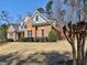 An eye-level view of a two-story brick home with landscaped yard at 112 Estates At The Lake Dr, Canton, GA 30114