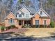Charming brick home featuring a well-manicured front yard and inviting curb appeal at 112 Estates At The Lake Dr, Canton, GA 30114