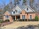 Beautifully landscaped front yard complements this classic two-story brick home at 112 Estates At The Lake Dr, Canton, GA 30114