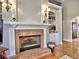 Living room fireplace with brick hearth, built-in shelving, and decorative mantle at 112 Estates At The Lake Dr, Canton, GA 30114