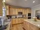 Bright kitchen with granite countertops, stainless appliances, and light wood cabinets at 112 Estates At The Lake Dr, Canton, GA 30114