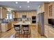 Bright kitchen featuring a center island, custom cabinets, and stainless steel appliances at 112 Estates At The Lake Dr, Canton, GA 30114