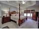 Comfortable main bedroom with a four-poster bed, decorative ceiling, and soft lighting at 112 Estates At The Lake Dr, Canton, GA 30114