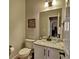 Half bathroom featuring a vanity with granite countertop, sink, and toilet at 112 Estates At The Lake Dr, Canton, GA 30114