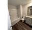 Bright bathroom features a shower-tub combo and gray vanity with granite counters at 116 Deer Xing, Temple, GA 30179