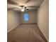 The carpeted bedroom has a ceiling fan and a window for great natural light at 116 Deer Xing, Temple, GA 30179
