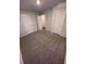 This carpeted bedroom has neutral walls, multiple doors, and ample closet space at 116 Deer Xing, Temple, GA 30179