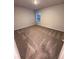 The carpeted bedroom has neutral walls, a window for natural light, and ample closet space at 116 Deer Xing, Temple, GA 30179