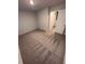 This carpeted bedroom has neutral walls, an ensuite bathroom, and ample closet space at 116 Deer Xing, Temple, GA 30179
