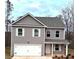 Charming two-story home with a gray exterior and a white garage door under a cloudy sky at 116 Deer Xing, Temple, GA 30179