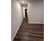 Hallway featuring hardwood floors and neutral gray wall paint at 116 Deer Xing, Temple, GA 30179