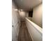 Carpeted hallway with neutral walls and base trim offers access to the upper level at 116 Deer Xing, Temple, GA 30179