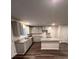 Modern kitchen featuring an island with granite countertops, gray cabinets, and hardwood flooring at 116 Deer Xing, Temple, GA 30179