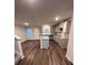 Modern kitchen featuring an island with granite countertops, gray cabinets, and hardwood flooring at 116 Deer Xing, Temple, GA 30179