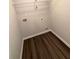 This laundry room has vinyl floors, and a utility shelf for storage at 116 Deer Xing, Temple, GA 30179