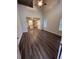 Bright living room featuring hardwood floors, a ceiling fan, and a view into a modern kitchen at 116 Deer Xing, Temple, GA 30179