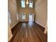 Bright living room featuring hardwood floors, a ceiling fan, and ample natural light from large windows at 116 Deer Xing, Temple, GA 30179