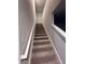 Carpeted stairway with white railing, offering a seamless transition between levels at 116 Deer Xing, Temple, GA 30179
