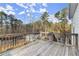 Deck with a wood railing with a view of the trees and backyard on a sunny day at 411 Spring Lake Hls, White, GA 30184