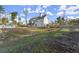 View of the back of the home with yard, fire pit, and outbuilding at 411 Spring Lake Hls, White, GA 30184