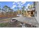 Backyard with fire pit and large patio area, offering lots of space for enjoyment at 411 Spring Lake Hls, White, GA 30184
