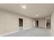 Unfinished basement with neutral color paneling and concrete floors, ready to be designed at 411 Spring Lake Hls, White, GA 30184