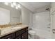 Well-lit bathroom with single sink vanity, granite countertop, and shower-tub combo, offering a functional space at 411 Spring Lake Hls, White, GA 30184