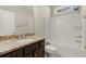 Bathroom features granite counters, wood cabinet, and shower-tub combo at 411 Spring Lake Hls, White, GA 30184