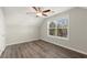 Bright, inviting bedroom boasts wood flooring, a large window, and neutral decor for a tranquil space at 411 Spring Lake Hls, White, GA 30184