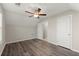 Spacious bedroom features vaulted ceiling, modern ceiling fan, and stylish wood floors for comfort and elegance at 411 Spring Lake Hls, White, GA 30184