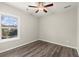 Bright bedroom features modern ceiling fan, window and beautiful wood-look floors at 411 Spring Lake Hls, White, GA 30184