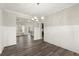 Open-concept dining area with hardwood floors and access to other living spaces at 411 Spring Lake Hls, White, GA 30184