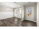 Elegant dining room with wainscoting, modern chandelier, and hardwood floors at 411 Spring Lake Hls, White, GA 30184