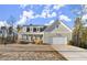 Charming two-story home with a covered front porch and attached two-car garage at 411 Spring Lake Hls, White, GA 30184