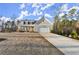 Charming home with a well-manicured lawn, dormer windows, and a large, attached two-car garage at 411 Spring Lake Hls, White, GA 30184