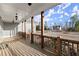 Spacious front porch with wood railings and an open view of the surrounding landscape at 411 Spring Lake Hls, White, GA 30184