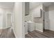 Laundry room equipped with modern washer and dryer, overhead cabinets, and wood style flooring at 411 Spring Lake Hls, White, GA 30184