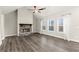Cozy living room with a stone fireplace, vaulted ceiling, and large windows at 411 Spring Lake Hls, White, GA 30184