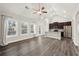 Open living area with vaulted ceiling, large windows, and access to the kitchen at 411 Spring Lake Hls, White, GA 30184