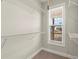 Walk-in closet provides ample storage space with adjustable shelving and natural light from a window at 411 Spring Lake Hls, White, GA 30184