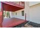 Exterior view of the home's lower deck with a stained wood floor and a white brick exterior at 4620 Central Dr, Stone Mountain, GA 30083